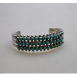 A Zuni turquoise cluster bracelet, designed with three rows of 14 small turquoise per row, about 5.