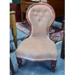 A Victorian mahogany framed buttoned spoonback nursing chair with overstuffed serpentine seat