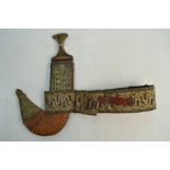 An Arab dagger jimbaya with decorative hilt and scabbard, on embroidered belt,