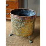 A 19th century copper and brass cylinder log bin on paw feet, 40 cm high x 40 cm dia.