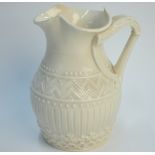A Belleek first period milk jug moulded with a harp shaped handle,