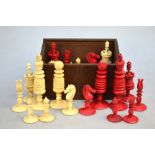 A 19th century ring-turned ivory chess-set with red dye, king 10.