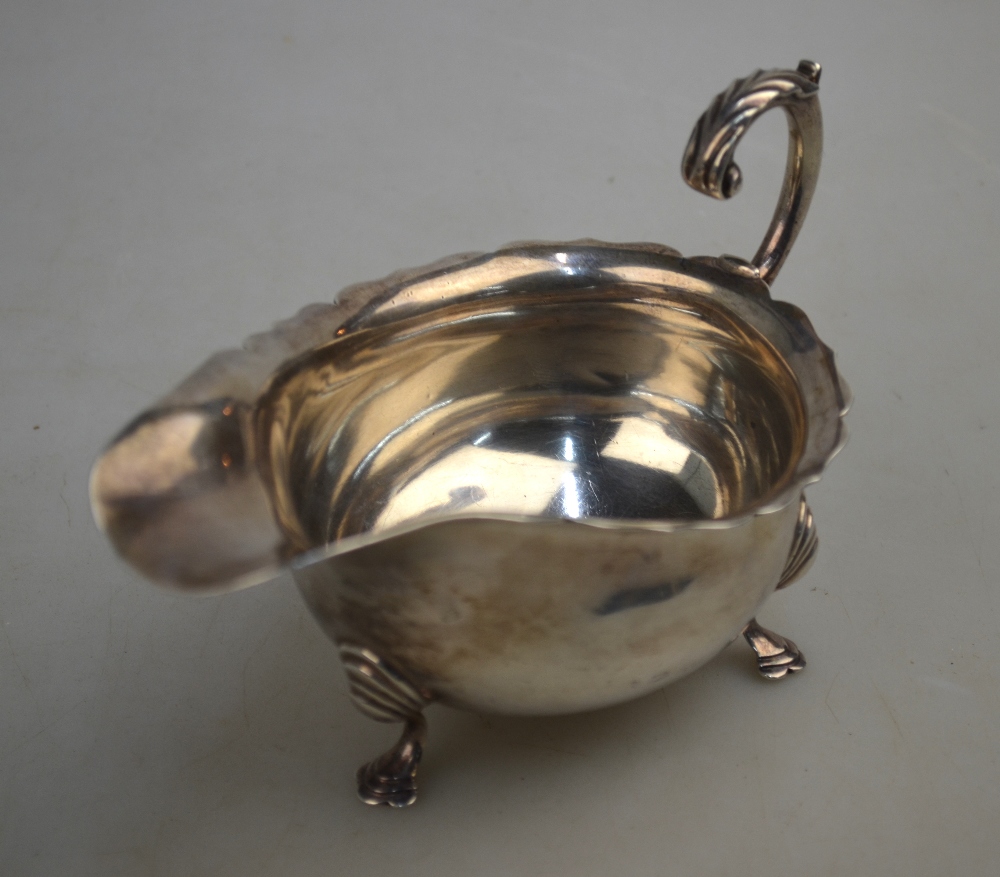 An Edwardian silver sauce boat with cut rim, scroll handle and hoof feet, Haseler Bros. - Image 2 of 4