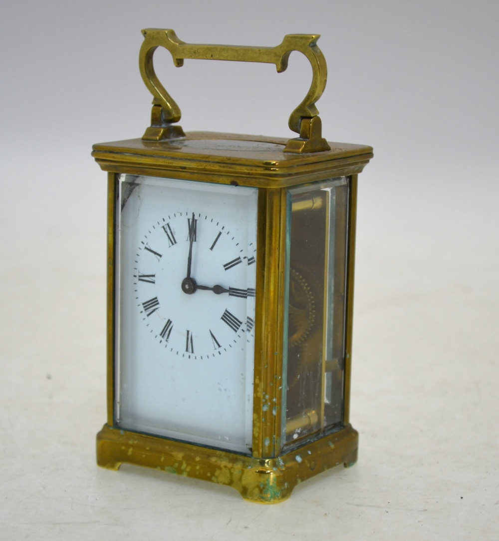 An English brass carriage clock with enamel dial, 15 cm high (including handle),