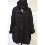 A black Persian lamb jacket with corded buttons,