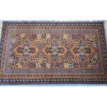 A belouch rug, the triple geometric medallion design on earthy tone ground,