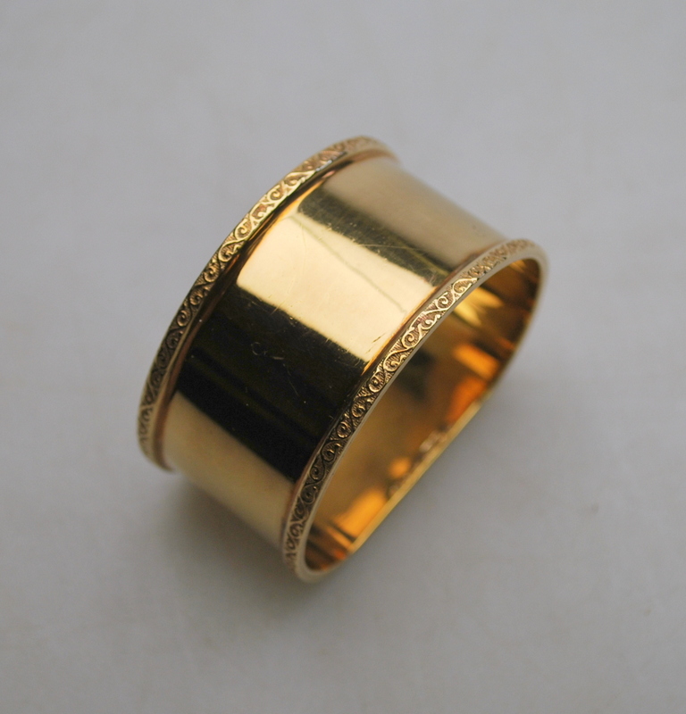 A 9ct yellow gold D-shaped napkin ring with cast scrolled edges approx 30g