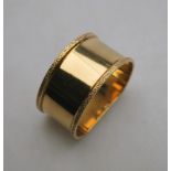 A 9ct yellow gold D-shaped napkin ring with cast scrolled edges approx 30g