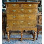 A William & Mary feather-banded walnut chest of two short over three long drawers,