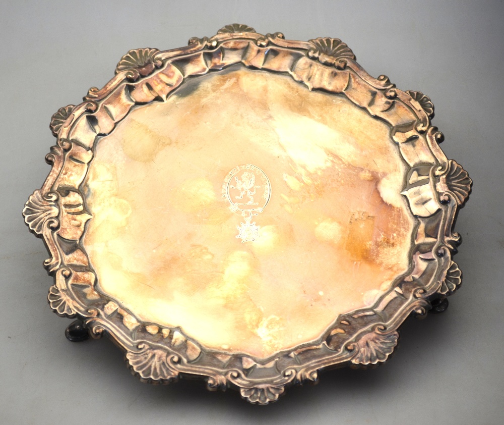 An early George III silver card salver with cast shell and scroll pie-crust border,