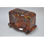 A serpentine tortoiseshell tea caddy with brass cartouches,