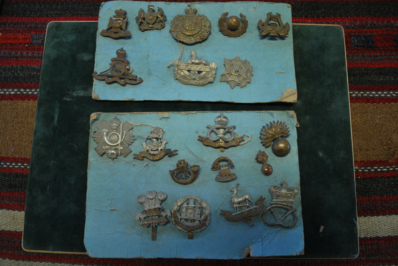 A small assortment of British military cap badges including Highland Light Infantry;