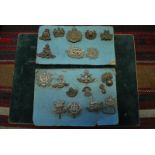 A small assortment of British military cap badges including Highland Light Infantry;