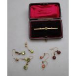 A peridot and small pearl bar brooch stamped 15ct to/w two pairs of peridot set drop earrings,