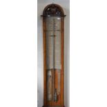 A Victorian Admiral Fitzroy forecasting barometer with printed paper scales and text within an oak