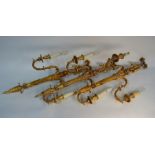A set of seven composite gilt finished ribbon top twin scroll arm wall sconces in the George II