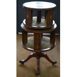 An inlaid satinwood two tier circular revolving bookcase of graduated form raised on a base