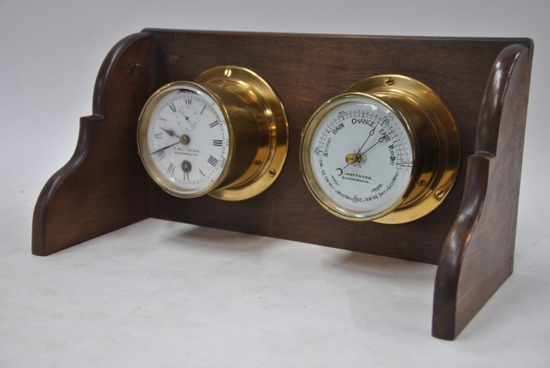 A brass marine barometer with matching clock, the 9 cm enamel dial inscribed for T.