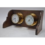 A brass marine barometer with matching clock, the 9 cm enamel dial inscribed for T.