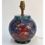 A Moorcroft contemporary table lamp, blue ground decorated with tube lined fruit and birds,