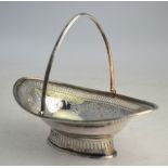 A George III Adam-style silver bonbon basket of navette form, with reeded swing handle and rims,