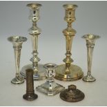A pair of loaded silver baluster candlesticks, London 1913, 23 cm high, to/w a short candlestick,