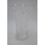A tall flared heavy cut glass vase raised on a circular foot with star cut base, 36.