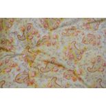 A pair of paisley yellow/red print vintage feather-filled eiderdowns,