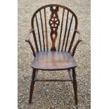 A 19th century yew and elm wheel back Windsor elbow chair