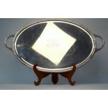 A large oval electroplated tray with reeded rim and twin handles,