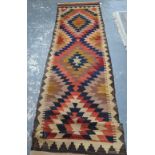 A Turkish kelim runner, the geometric triple diamond pole design executed in mixed colours,