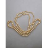 A two-row graduated cultured pearl necklace having Art Deco lozenge-shaped clasp,