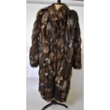 A light brown, flecked white fox fur coat with neat collar,