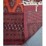 A Turkoman carpet red/brown ground with stylised gul design overall, 3.