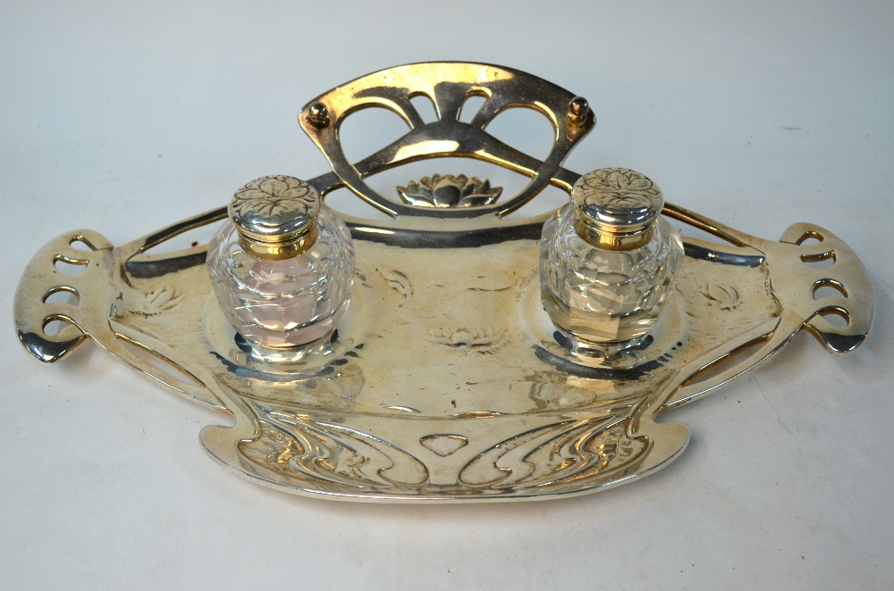 A German Art Nouveau style electroplated inkstand fitted with two cut glass bottles, 37 cm wide,