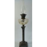 An electroplated classical column oil lamp with cut glass font