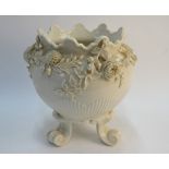 A Belleek second period jardiniere raised on three scrolling feet decorated in bold relief with