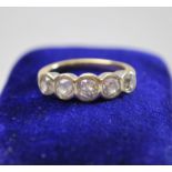 A five stone old cut diamond ring in white metal collet setting, approx 0.