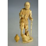 A sectional ivory okimono of a Japanese man with his hair cut in sakayaki, 14cm high,