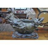 An Art Nouveau style bronzed spelter table centre piece cast with a sea-nymph with serpent,