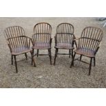 A close matched set of four 19th century elm Windsor armchairs having hoop and spindle backs,