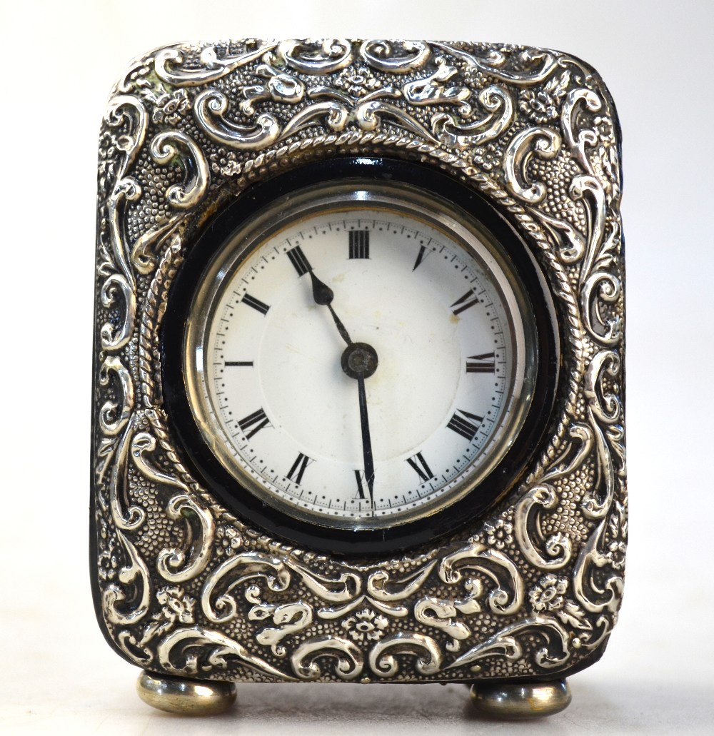 An Edwardian leather-cased desk clock with embossed silver face, Birmingham 1904,