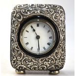 An Edwardian leather-cased desk clock with embossed silver face, Birmingham 1904,