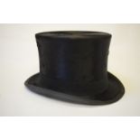 A vintage black silk top hat, size 7-1/8, 20 cm front to back, 17 cm across, retailed by H. M.