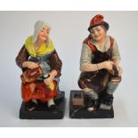 A pair of early 19th century Staffordshire figures of a cobbler and his wife,