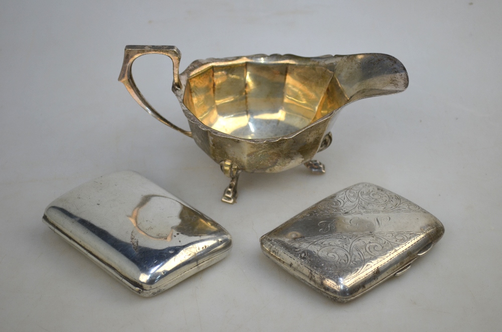 A small silver sauce-boat, Birmingham 1939, to/w two Edwardian cigarette cases,