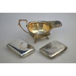 A small silver sauce-boat, Birmingham 1939, to/w two Edwardian cigarette cases,