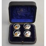 An unusual Edwardian cased set of four menu-holders, modelled with artists' palettes,