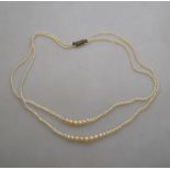 A double row of possibly natural untested graduated pearls on metal snap,