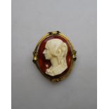 A cameo style brooch of ringleted female on agate background, enclosing hairwork to back,